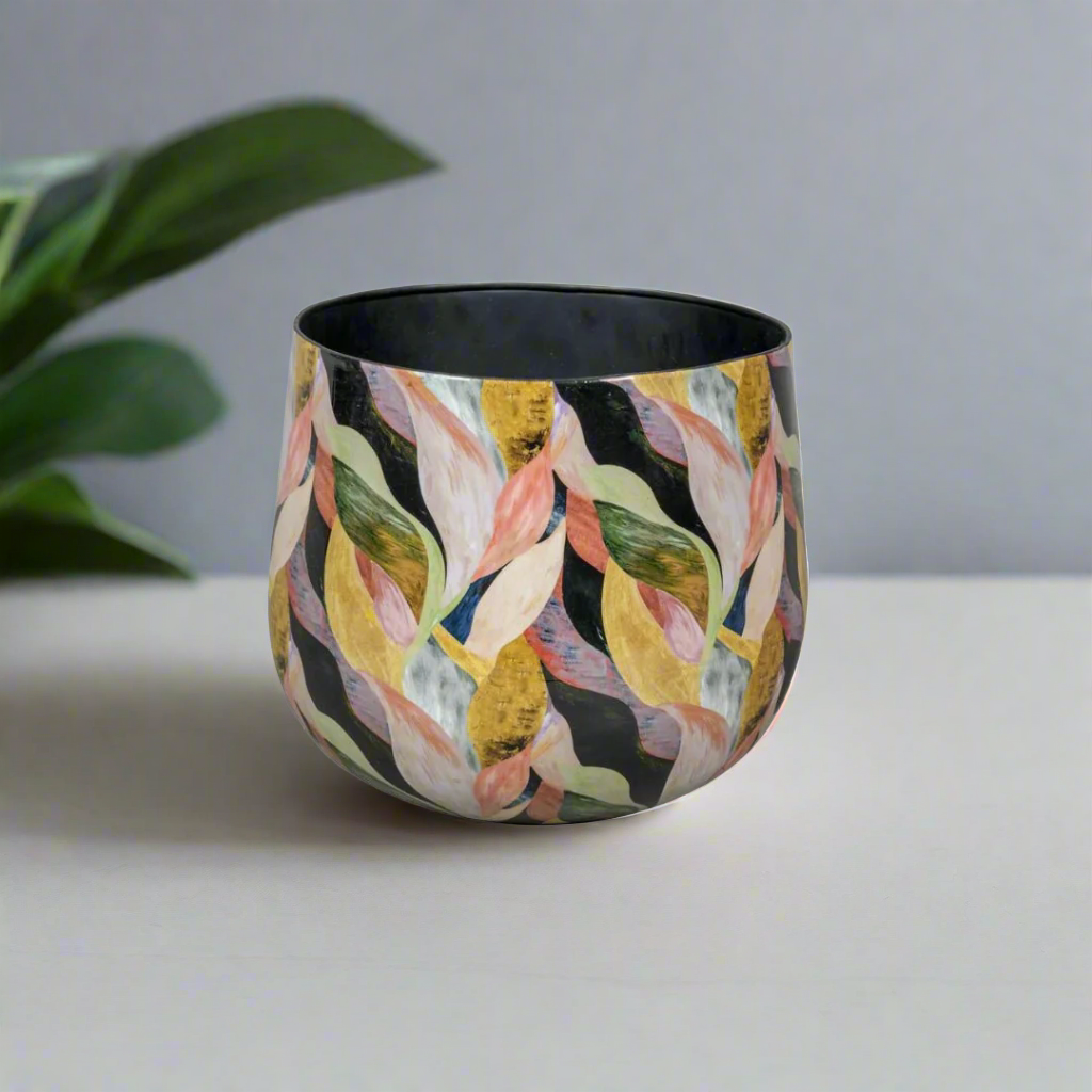 Decorative pot with colorful leaf pattern on a white background
