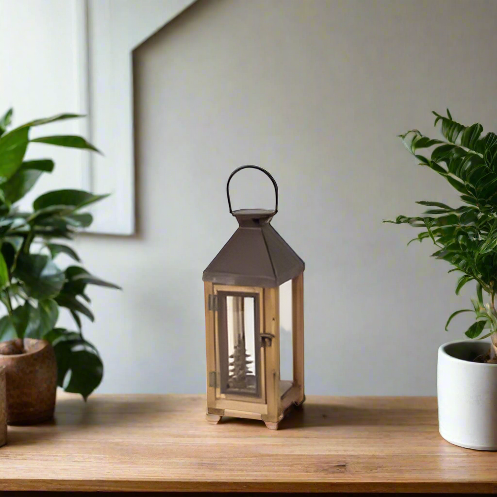 Small lantern with wooden frame and metal accents on a white background