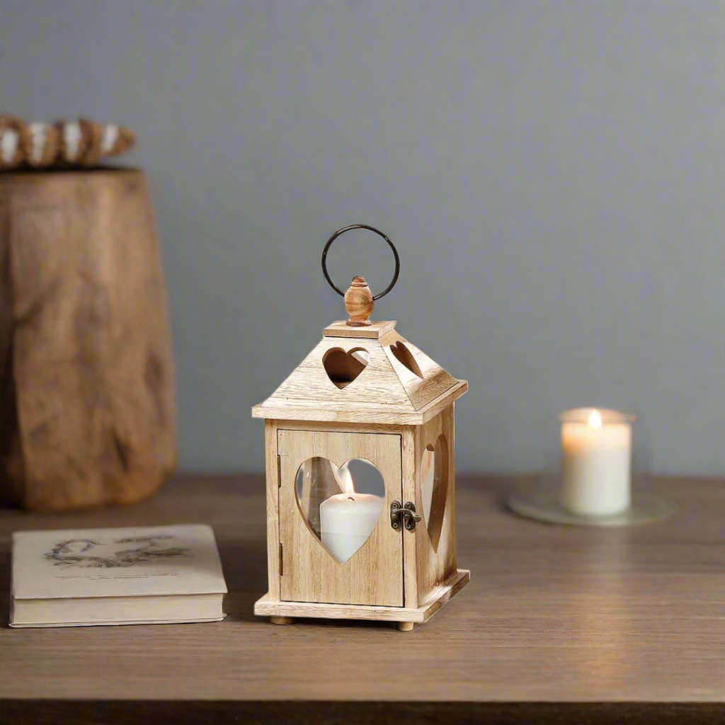 Wooden lantern with heart-shaped cutouts on a white background