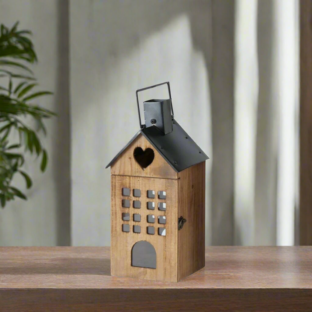 Wooden lantern with a black roof and heart-shaped cutout on a white background