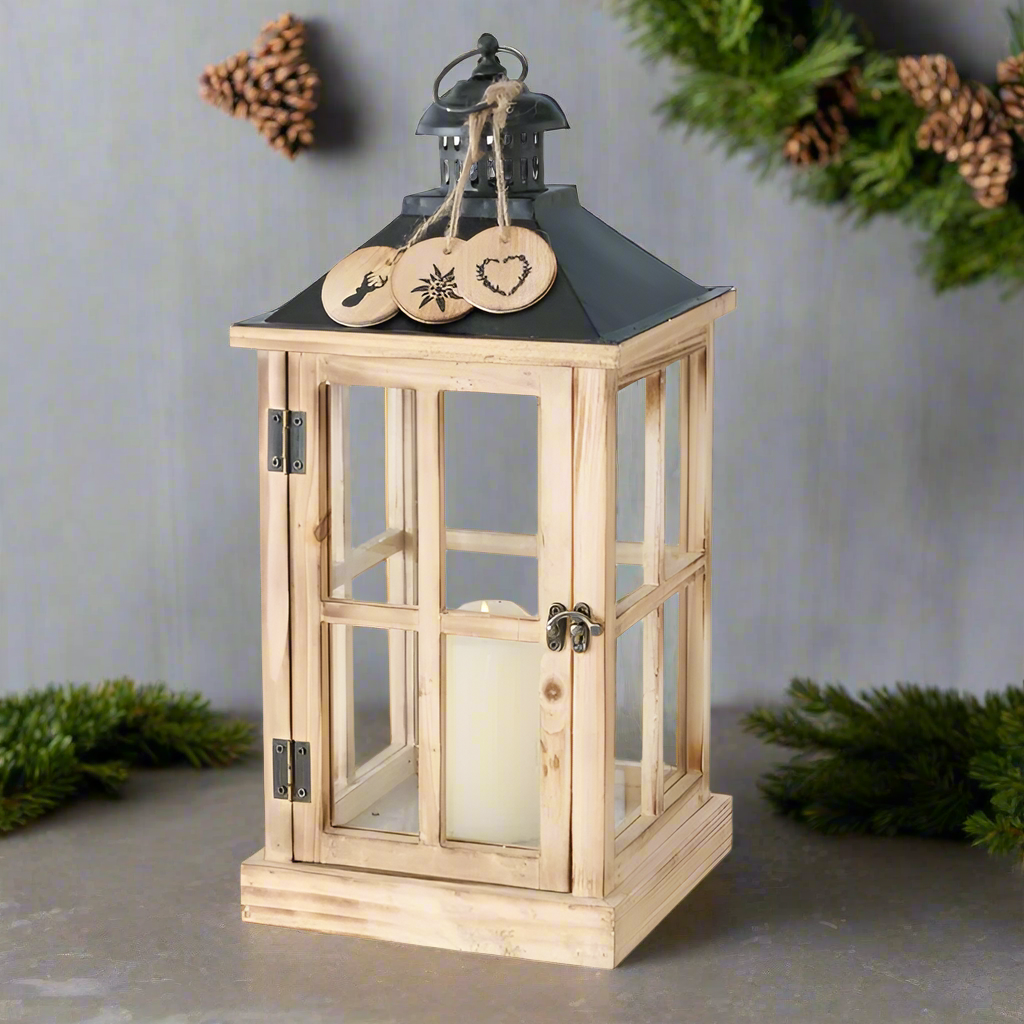 Wooden lantern with a black roof and decorative elements on a white background